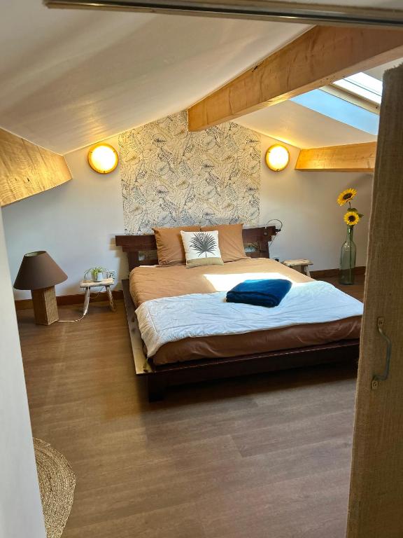 a bedroom with a large bed in a attic at Maison piscine &amp; spa Vallon Pont d&#39;Arc in Vallon-Pont-dʼArc
