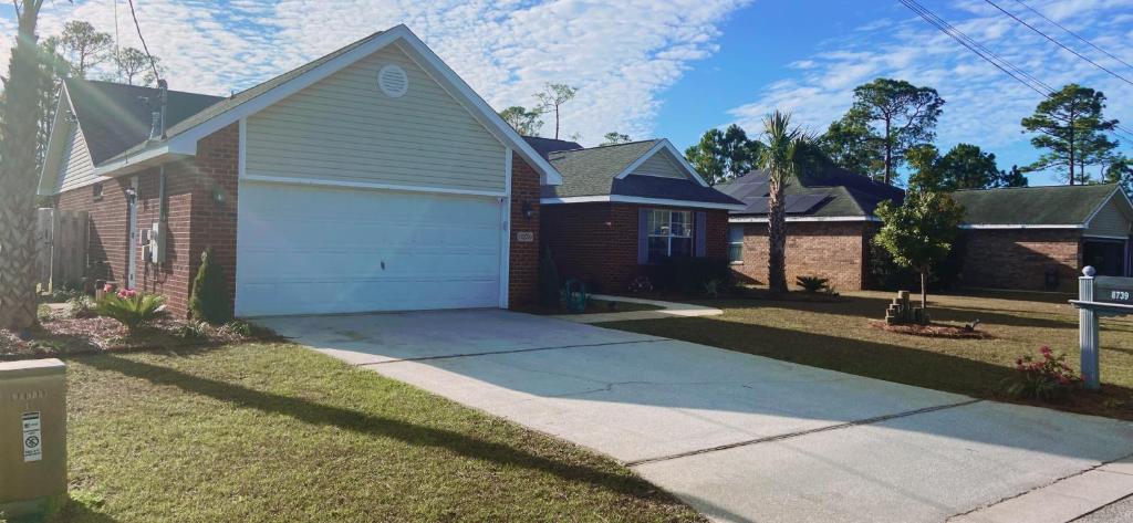 a house with a driveway and a garage at Sea Largo in Navarre