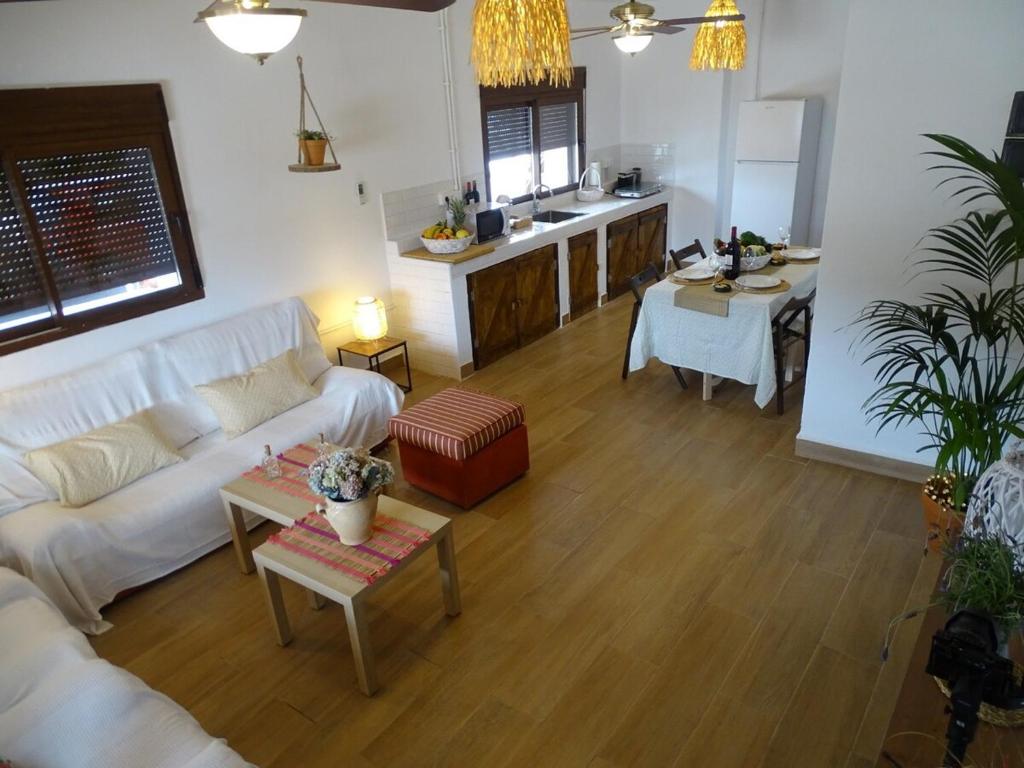 a living room with a white couch and a kitchen at Alojamiento vacacional Calblanque junto Cabo de Palos in Playa Honda