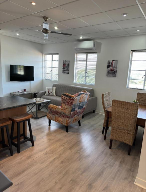 a waiting room with a couch and chairs and a table at The Muscadel - Paarl - Self Catering Apartment in Paarl