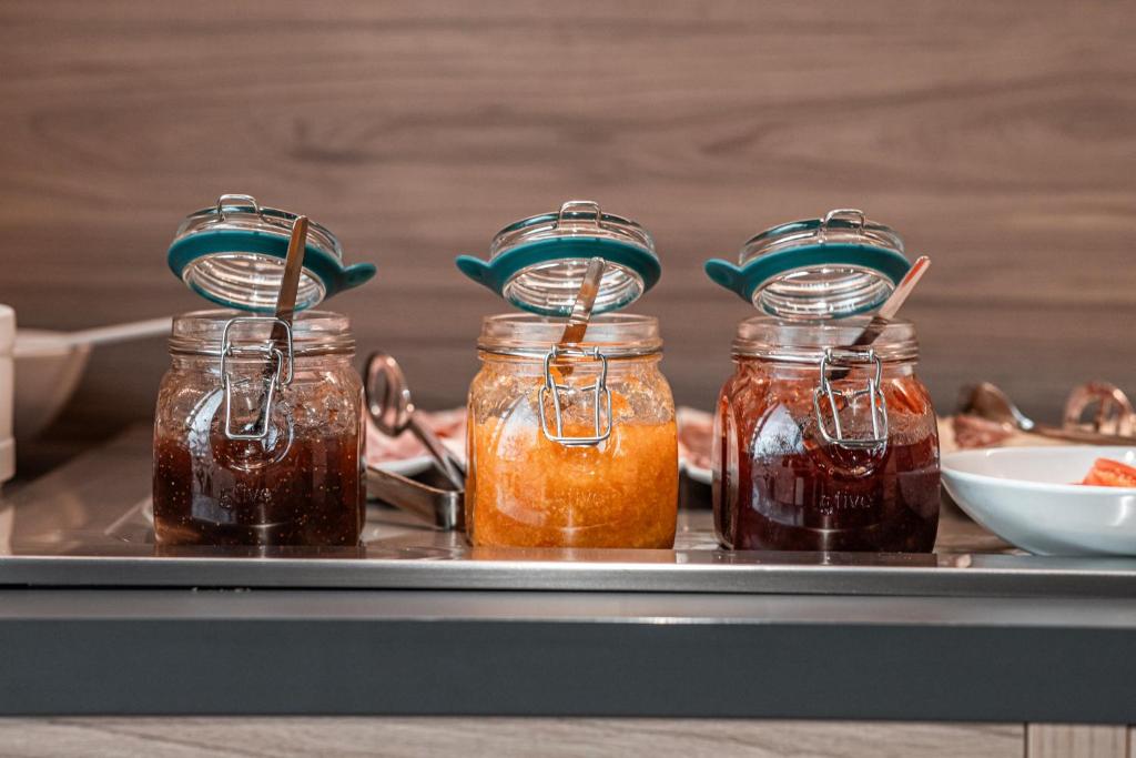 three jars of honey sitting on a tray at Holiday Inn Express Ajaccio by IHG in Ajaccio