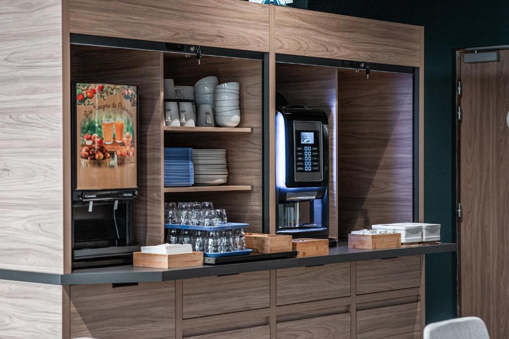 a counter with a coffee maker and a microwave at Holiday Inn Express Ajaccio by IHG in Ajaccio