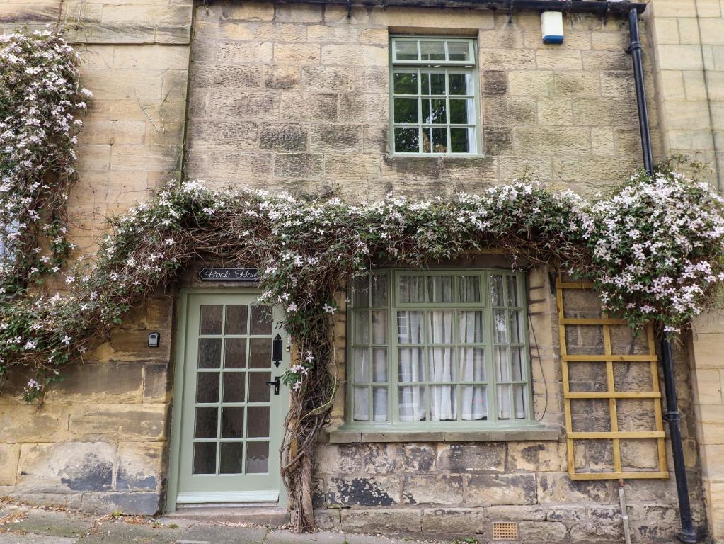 a building with a window with flowers on it at The Book House in Warkworth