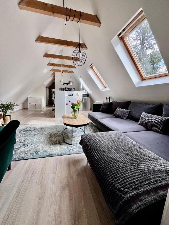 a living room with a couch and a table at Chalúpka in Stará Ľubovňa