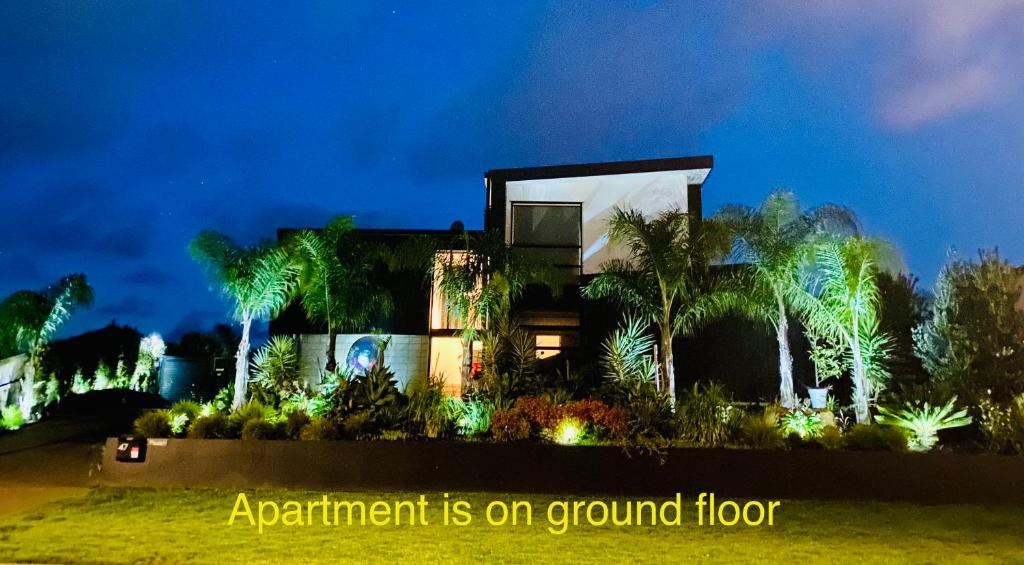 an apartment is on a ground floor at night at Private Papamoa Beach Paradise in Papamoa