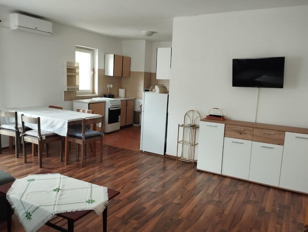 eine Küche und ein Wohnzimmer mit einem Tisch und einem Kühlschrank in der Unterkunft Apartment Sinčić in Kastav