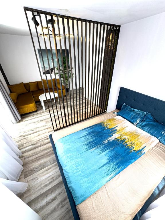 a bedroom with a large bed with a ironigunigun at Azzur Studios Aparthotel in Constanţa
