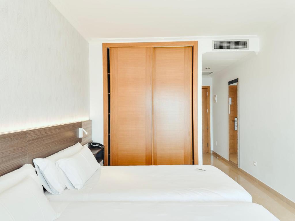Postel nebo postele na pokoji v ubytování Hotel Mardevela