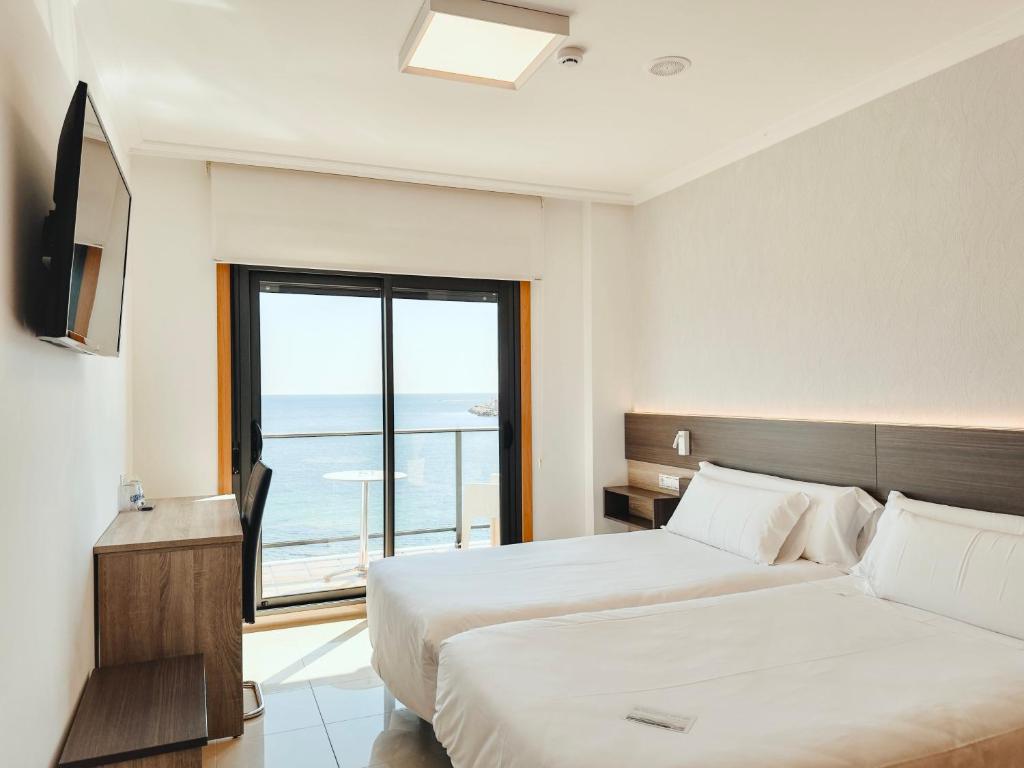 Postel nebo postele na pokoji v ubytování Hotel Mardevela