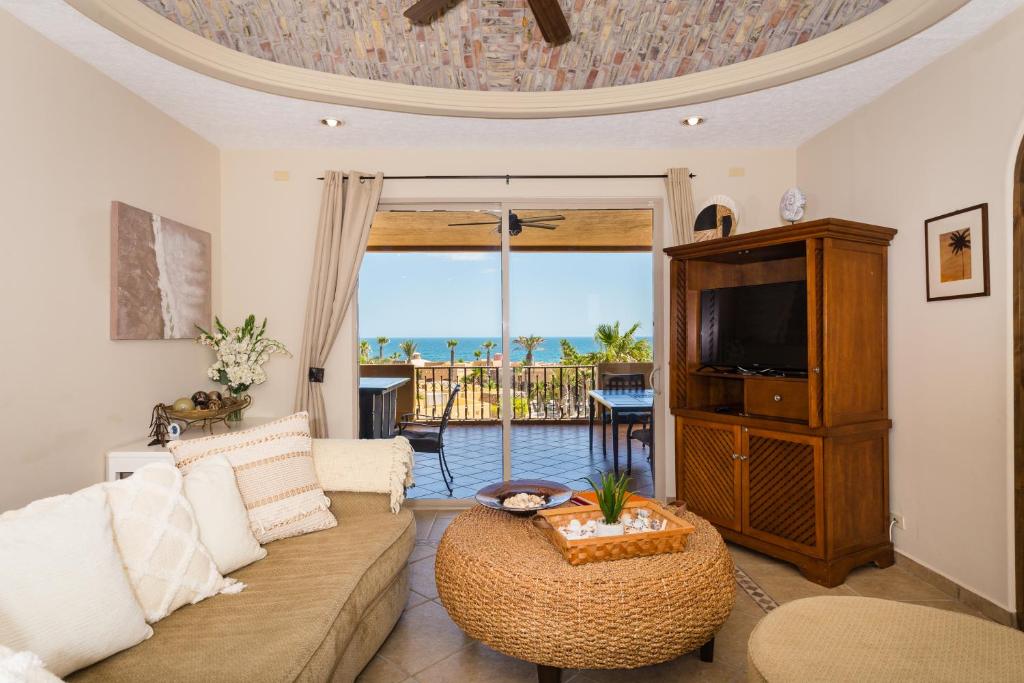 a living room with a couch and a tv at Bella Sirena Condo 201-E - Elegant Condo with Sunrise Sea Views in Puerto Peñasco