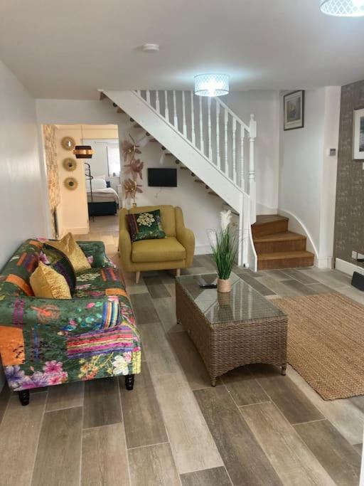 a living room with a couch and a table at Rockley Green House - 3 Bedroom Home in Liverpool in Liverpool