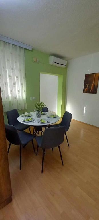 a dining room with a table and chairs in a room at ANTONIJ Apartment Gevgelija in Gevgelija