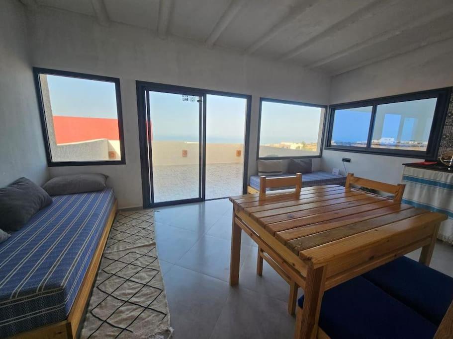 a living room with a wooden table and a couch at apartment vue Mer in Agadir