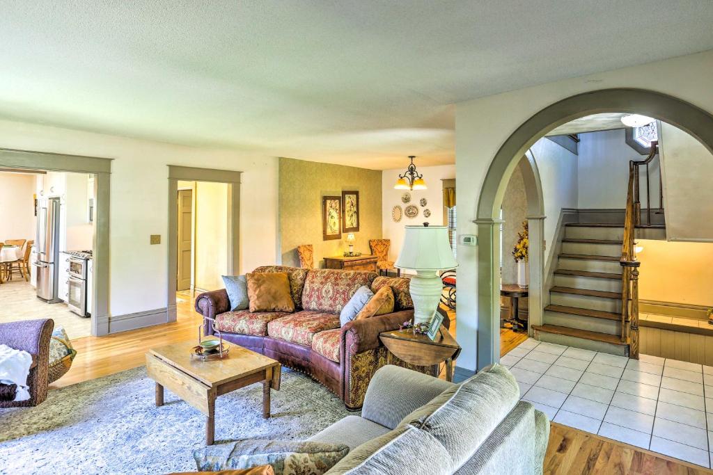 a living room with a couch and a table at Walk to Dtwn Historic Gem with Deck in Rapid City in Rapid City