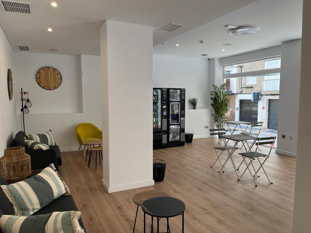 a living room with a couch and a table and chairs at Fleming Center by Punta 25 Hotels Group in Benidorm