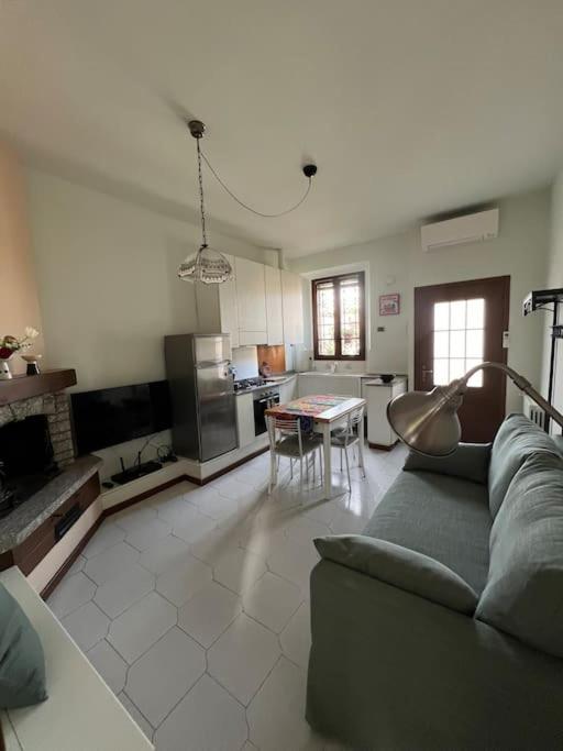 a living room with a couch and a kitchen at Casa di Fausto - CityLife Apartment in Milan