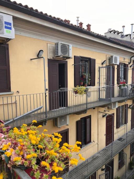 an apartment building with balconies and windows and flowers at Casa di Fausto - CityLife Apartment in Milan