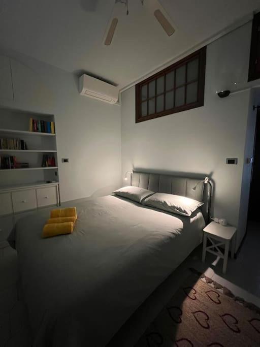 a bedroom with a large white bed and a chair at Casa di Fausto - CityLife Apartment in Milan