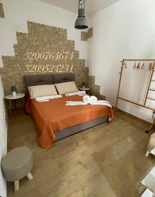 a bedroom with a bed and a stone wall at U Curtigliu apartment in Realmonte