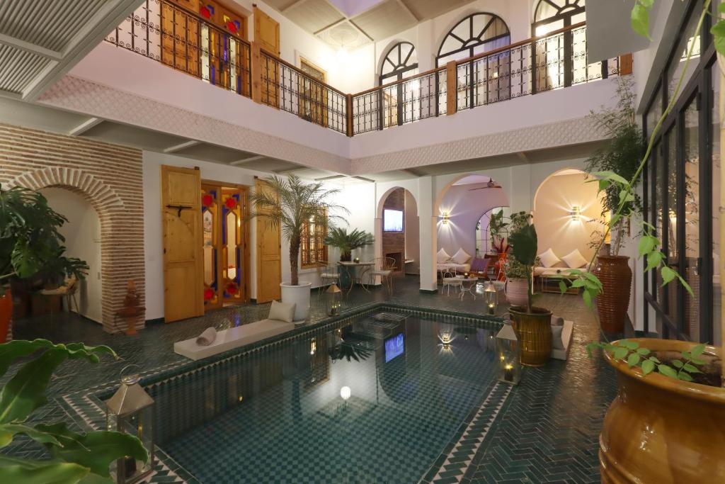 an indoor swimming pool in a building with arium at Riad Darchica in Marrakech