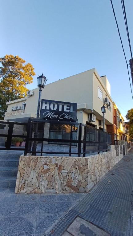 a hotel new era sign in front of a building at Hotel Mon Chéri in Villa Carlos Paz