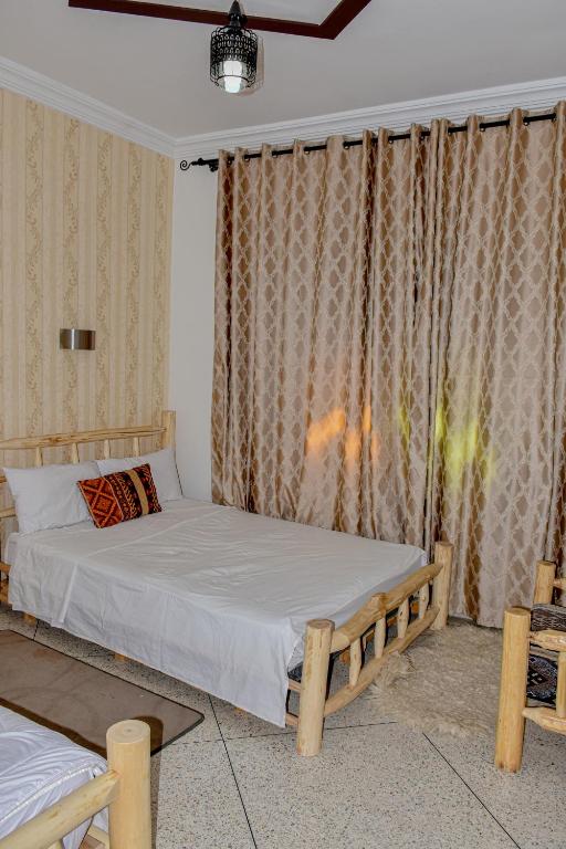 Postel nebo postele na pokoji v ubytování Hotel Safari Week end