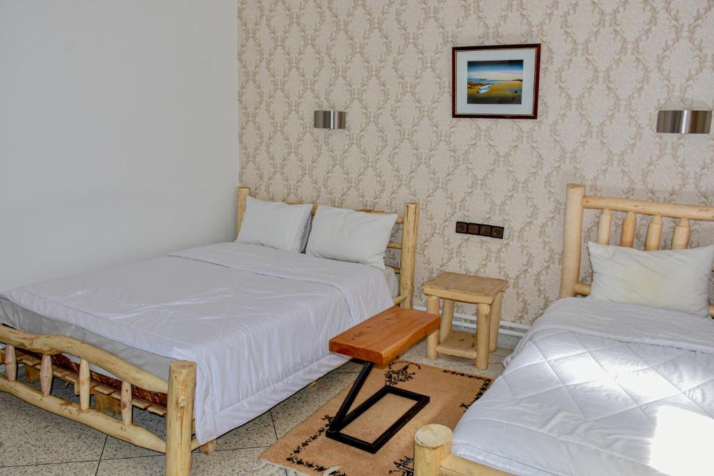 Postel nebo postele na pokoji v ubytování Hotel Safari Week end
