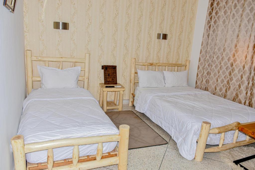 Postel nebo postele na pokoji v ubytování Hotel Safari Week end