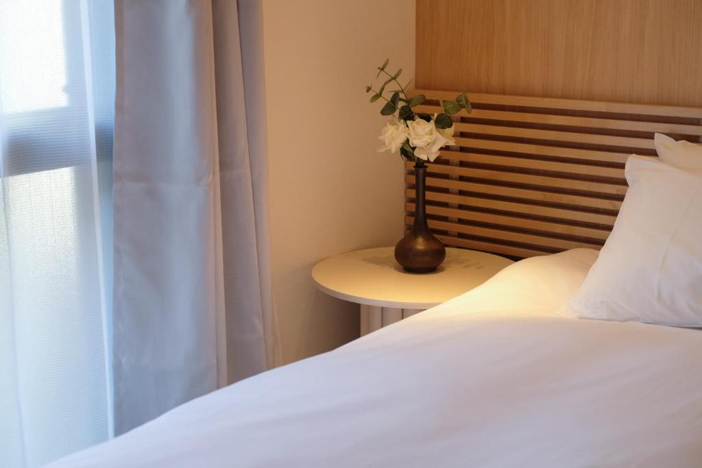 Postel nebo postele na pokoji v ubytování MKG Home・芝