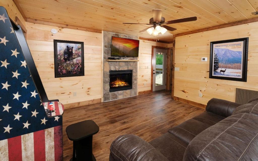 a living room with a couch and a fireplace at Wine Not in Gatlinburg
