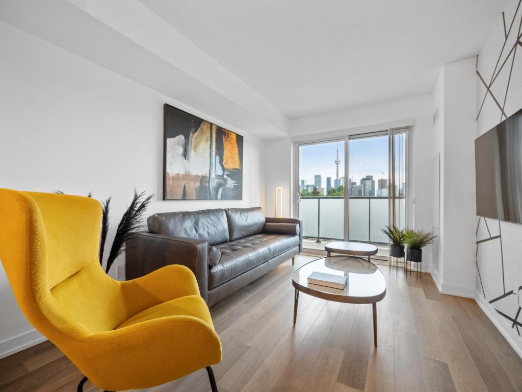 a living room with a couch and a table at Sleek 1BR & office Condo - CN Tower, Skyline view in Toronto