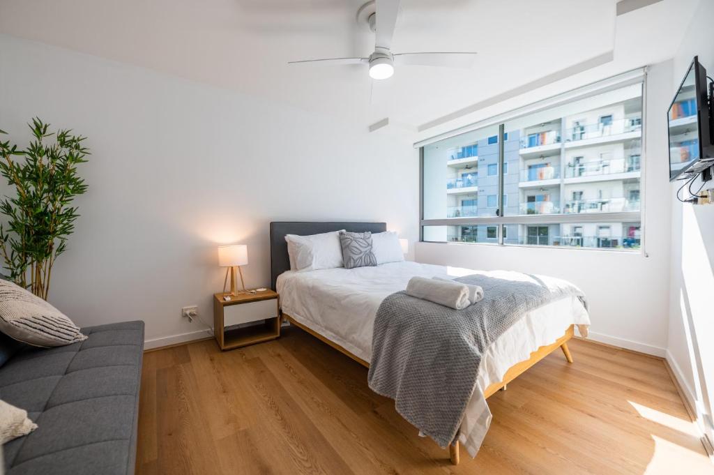 a bedroom with a bed and a large window at 3-Bedroom Unit with River Views and Balcony in Brisbane