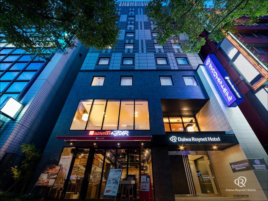a tall building with a store in front of it at Daiwa Roynet Hotel Chiba Ekimae in Chiba