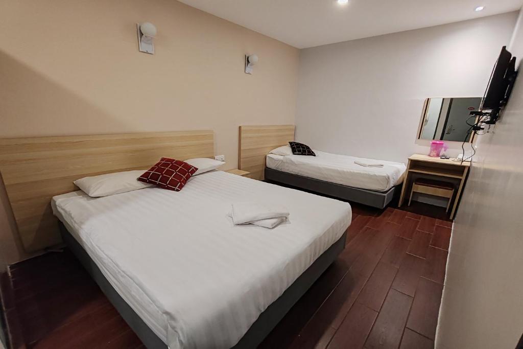 Postel nebo postele na pokoji v ubytování Hotel 18 DIMILIKI OLEH HOTEL MY HOME STATION 18 SDN BHD