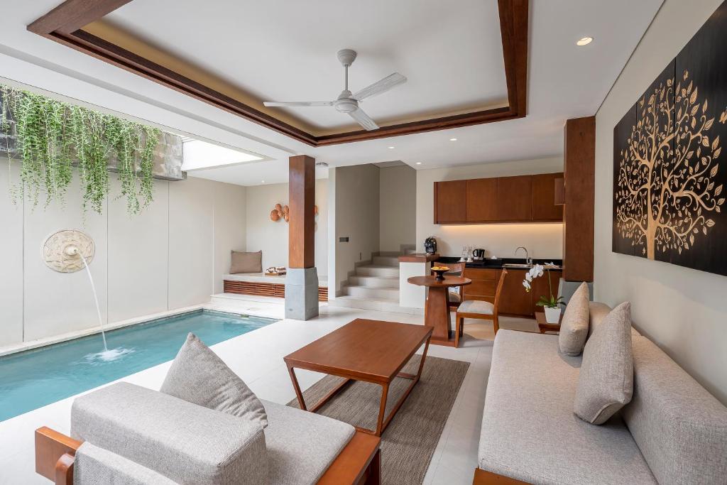 a living room with a swimming pool in a house at Tanadewa Villas Nusa Dua Bali by Cross Collection in Nusa Dua