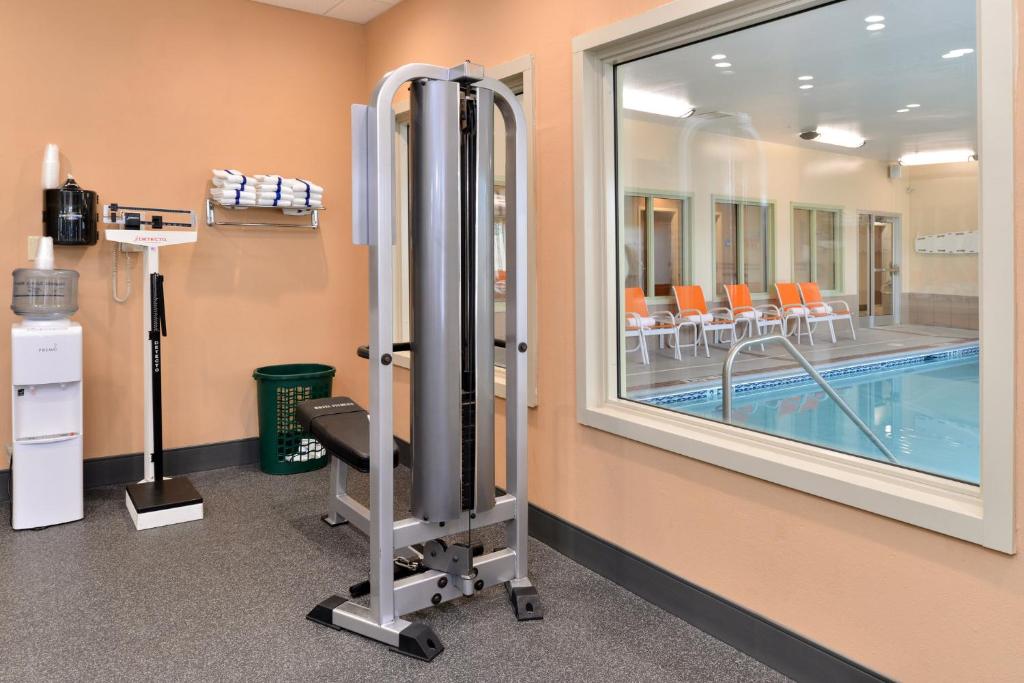 a therapy room with a swimming pool and a window at Holiday Inn Express Hotel & Suites Cincinnati-Blue Ash by IHG in Blue Ash