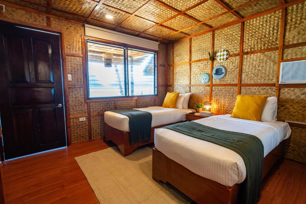 Postel nebo postele na pokoji v ubytování Beach Huts El Nido