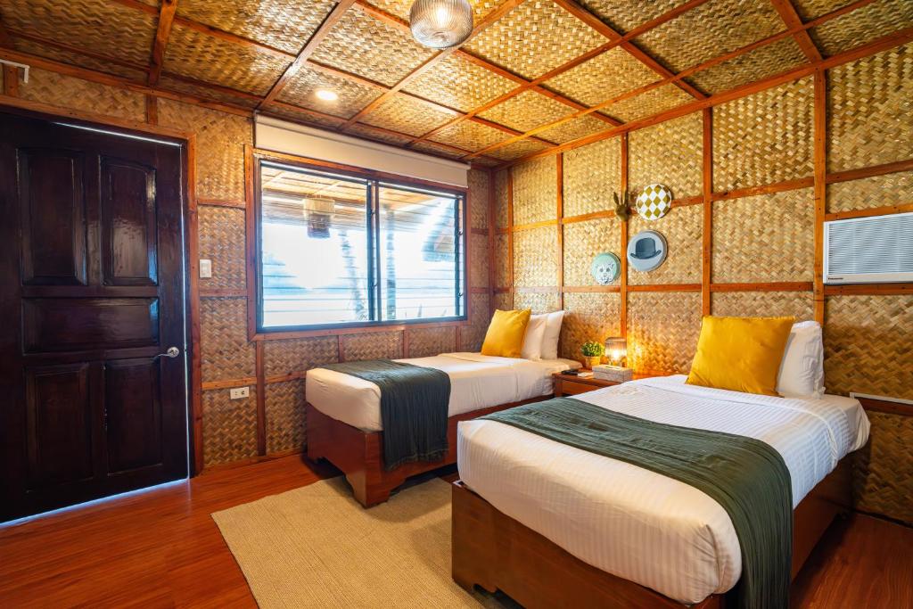 Postel nebo postele na pokoji v ubytování Beach Huts El Nido