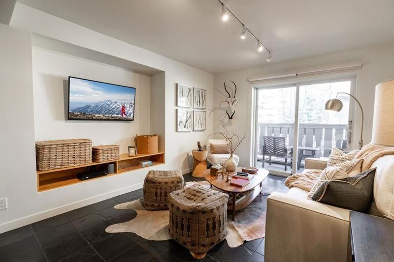 a living room with a couch and a table at Condo with Onsite Pool & Hot Tub, Free WiFi & Garage Parking in Vail