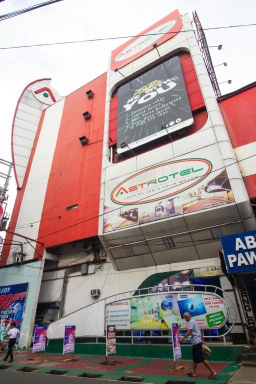 a building with signs on the side of it at Astrotel Novaliches in Manila