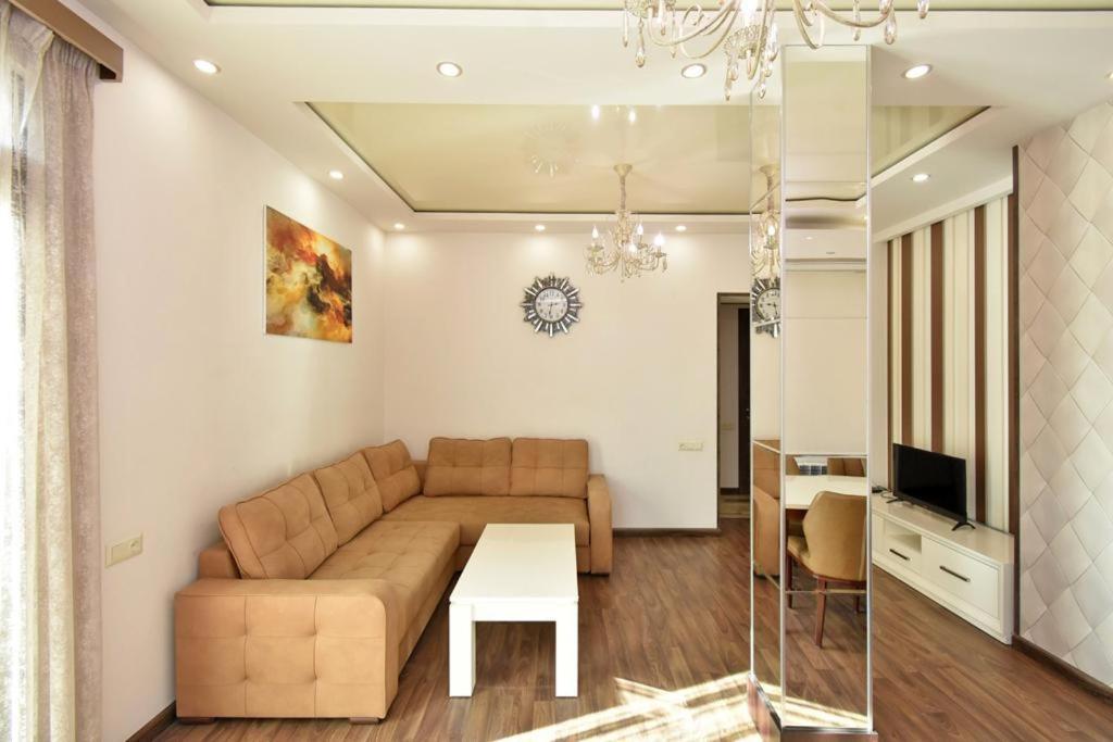 a living room with a couch and a table at Luxe Apartment in the Center of Yerevan 007 in Yerevan