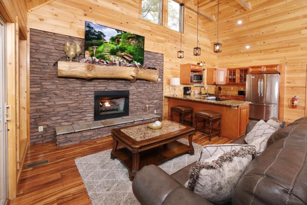 a living room with a fireplace in a log cabin at Swept Away in Gatlinburg