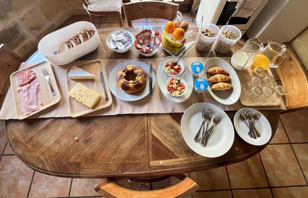une table en bois avec des assiettes de nourriture dans l'établissement Sant Antnin B&B, à Munxar