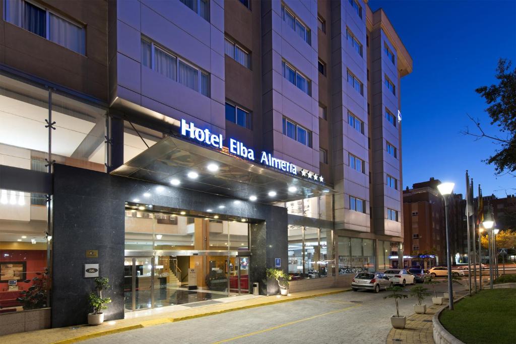 an exterior view of a hotel at night at Elba Almeria Business & Convention Hotel in Almería