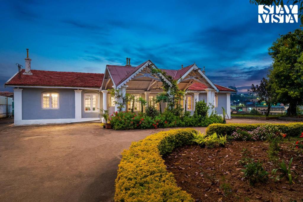 a house with a driveway in front of it at StayVista at The Alcove with Breakfast & BBQ Grill in Ooty