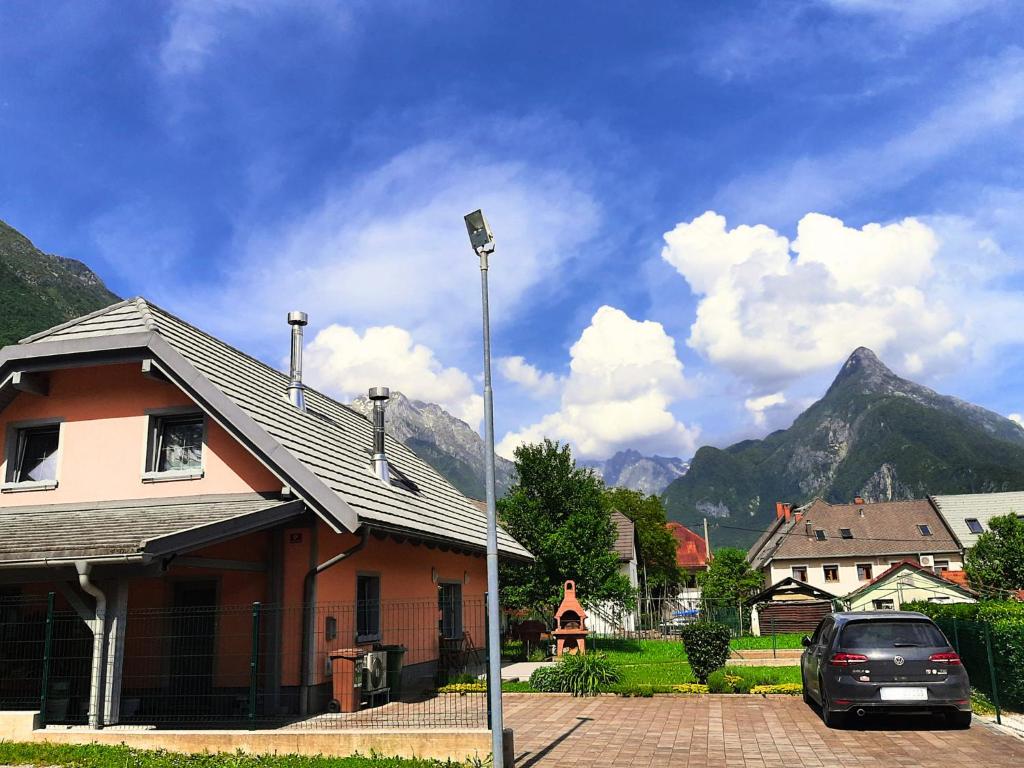 a car parked in front of a house with mountains at Apartment Pr&#39; Štajercu with Free Onsite Parking in Bovec