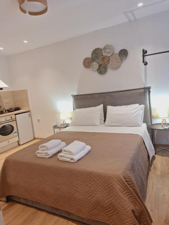 a bedroom with a large bed with towels on it at Studio Theotoki 2 in Corfu Town