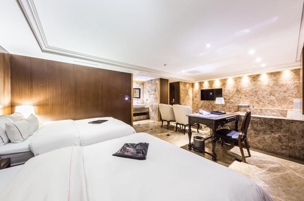 Postel nebo postele na pokoji v ubytování Hotel Cullinan Wangsimni