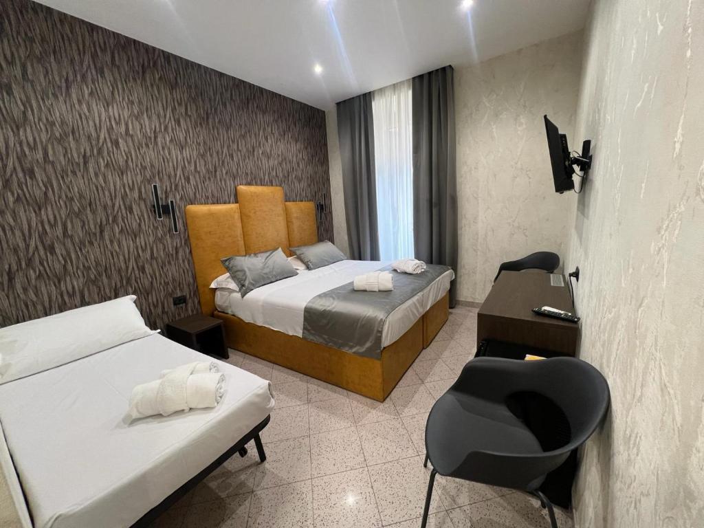 Postel nebo postele na pokoji v ubytování Hotel Ercoli House