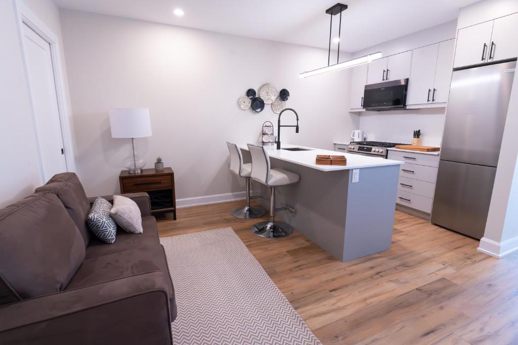 a living room with a couch and a kitchen at Capital Apartments in Ottawa